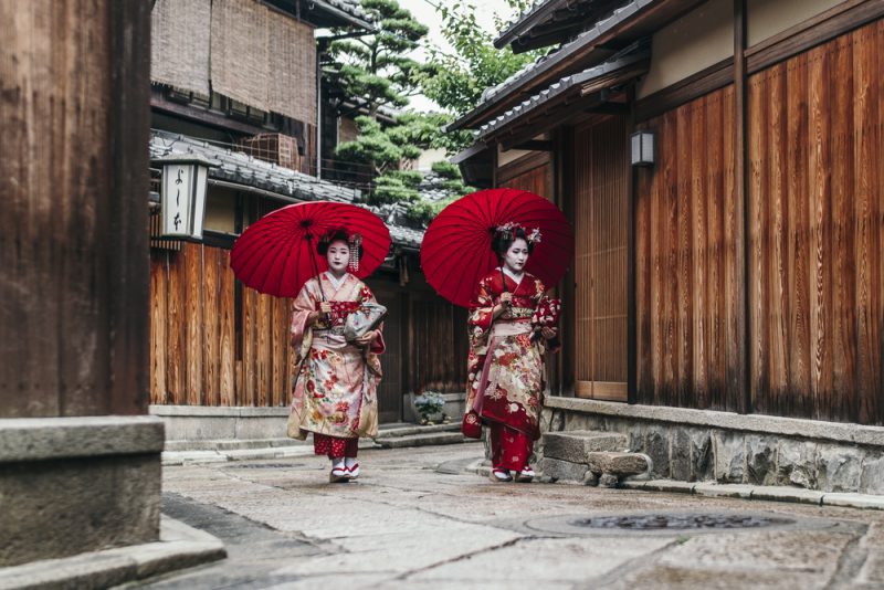 Maiko geisha walking on a street of Gion in Kyoto Japan