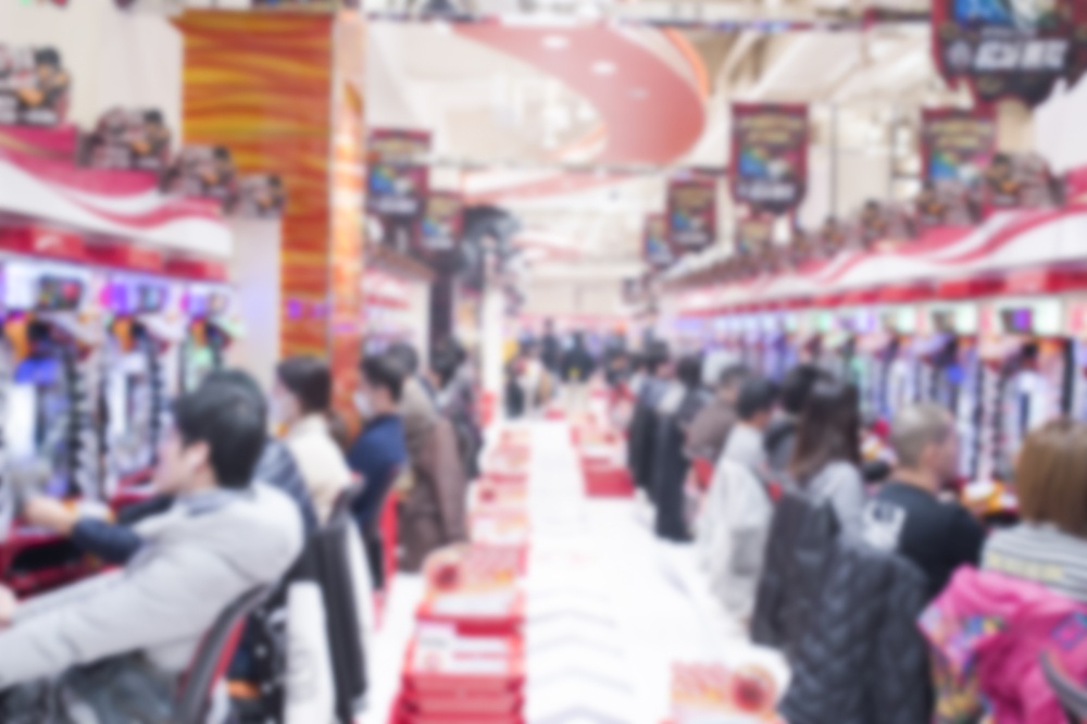 Blurred people playing Pachinko slot machine in Akihabara