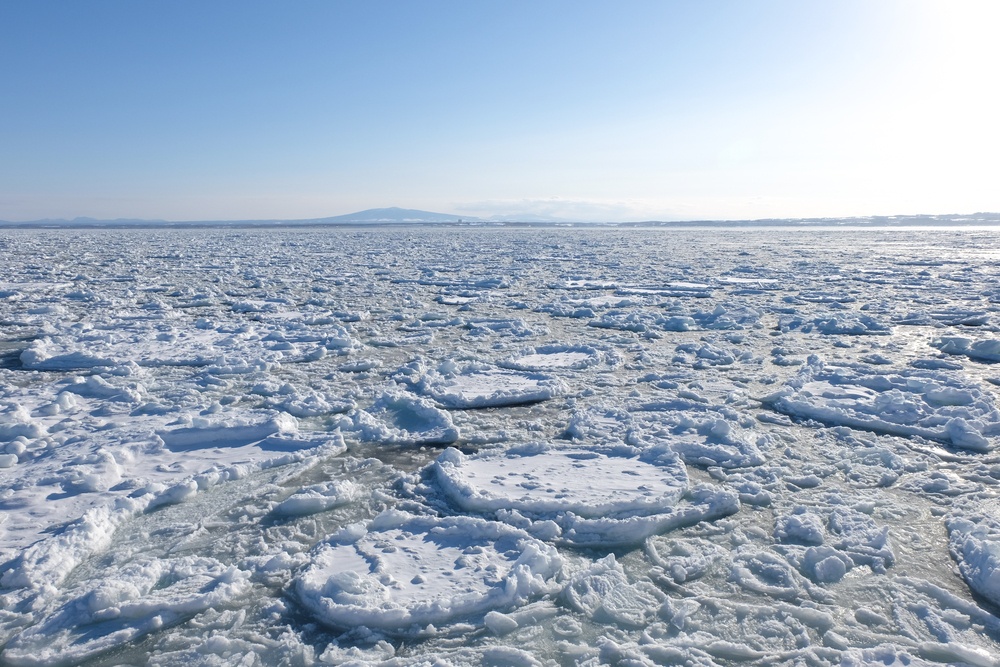 Drift Ice, Far mountain and blue Sky. Okhotsk Abashiri in winter