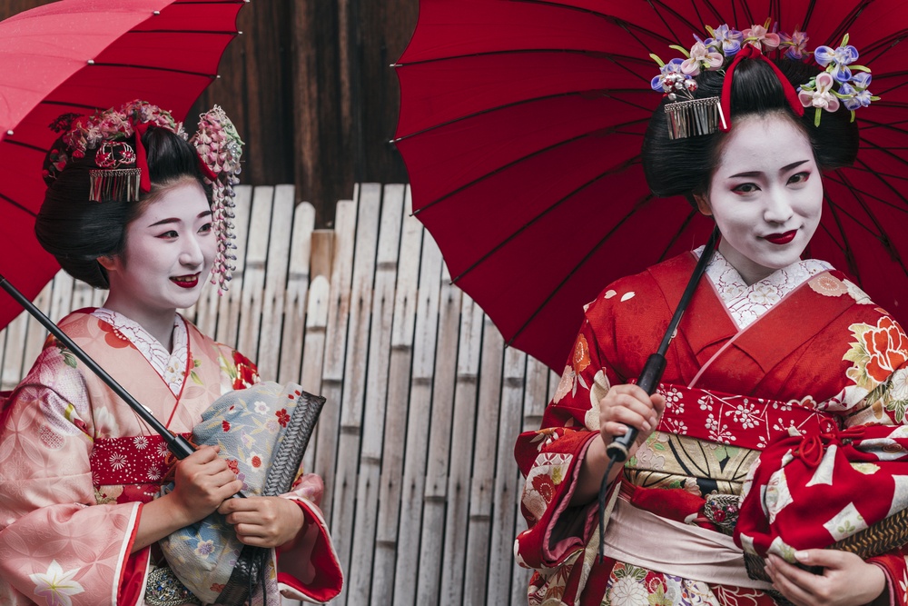 Maiko geisha walking on a street of Gion in Kyoto Japan