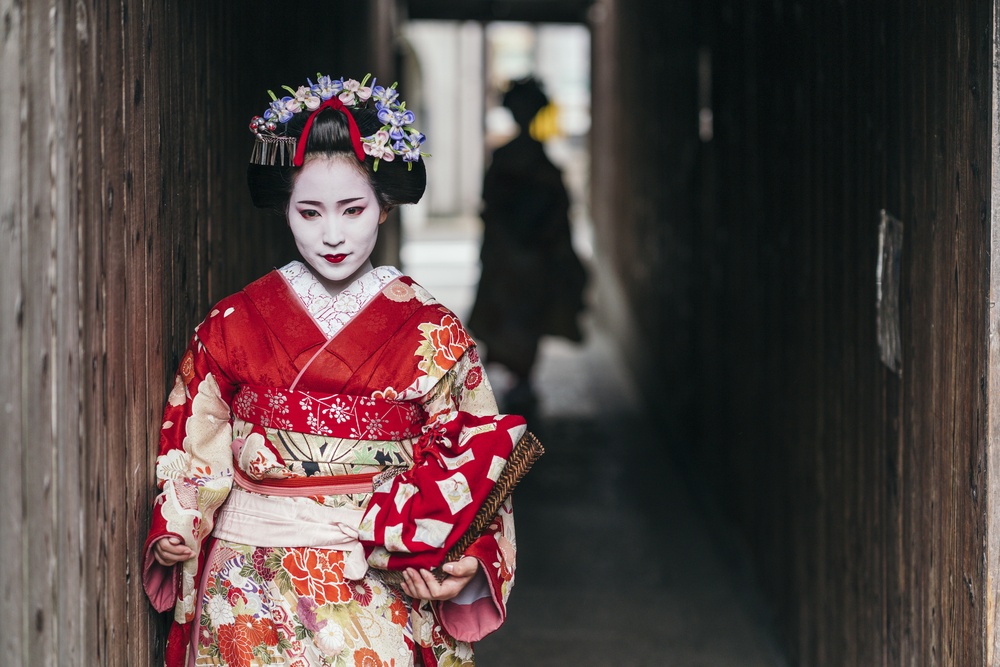 Maiko geisha walking on a street of Gion in Kyoto Japan 1