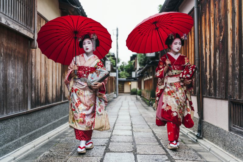 Maiko geisha walking on a street of Gion in Kyoto Japan